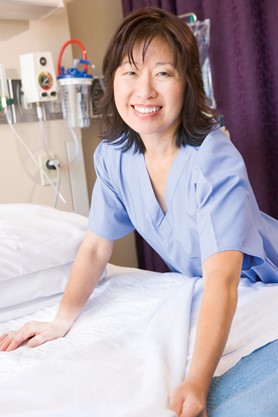 Nurse with clean bedsheets